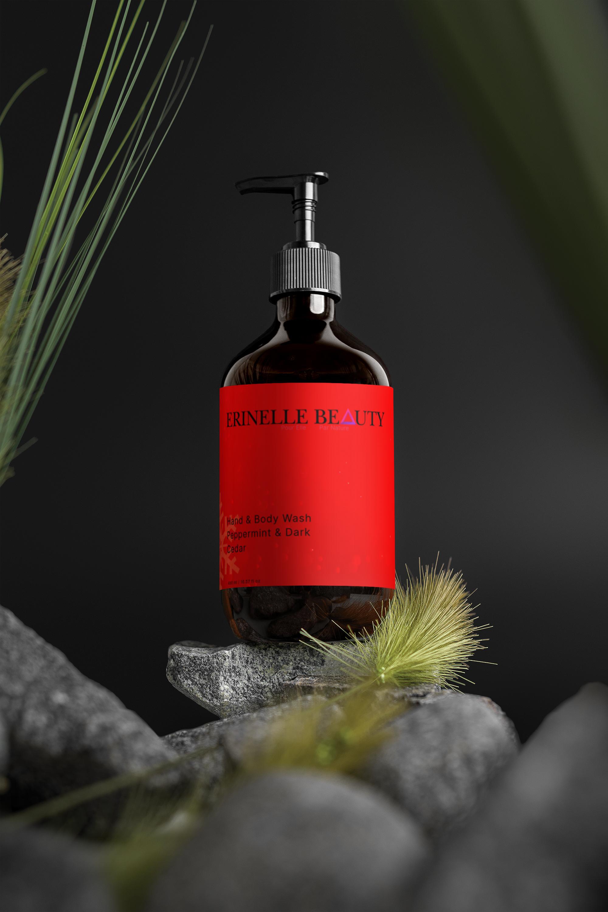 Erinelle Beauty natural peppermint and cedar body wash in a pump bottle with red label on rocks and green plants